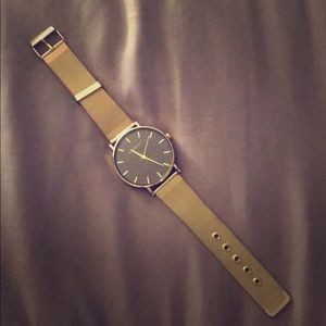 Gold watch with black sparkly face